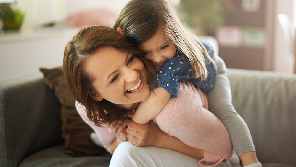 Mother and daughter smiling