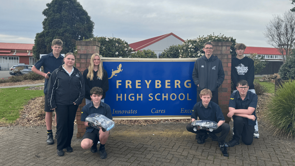 Freyberg High School students with their hydrogen remote controlled car and The Gas Hub's car.