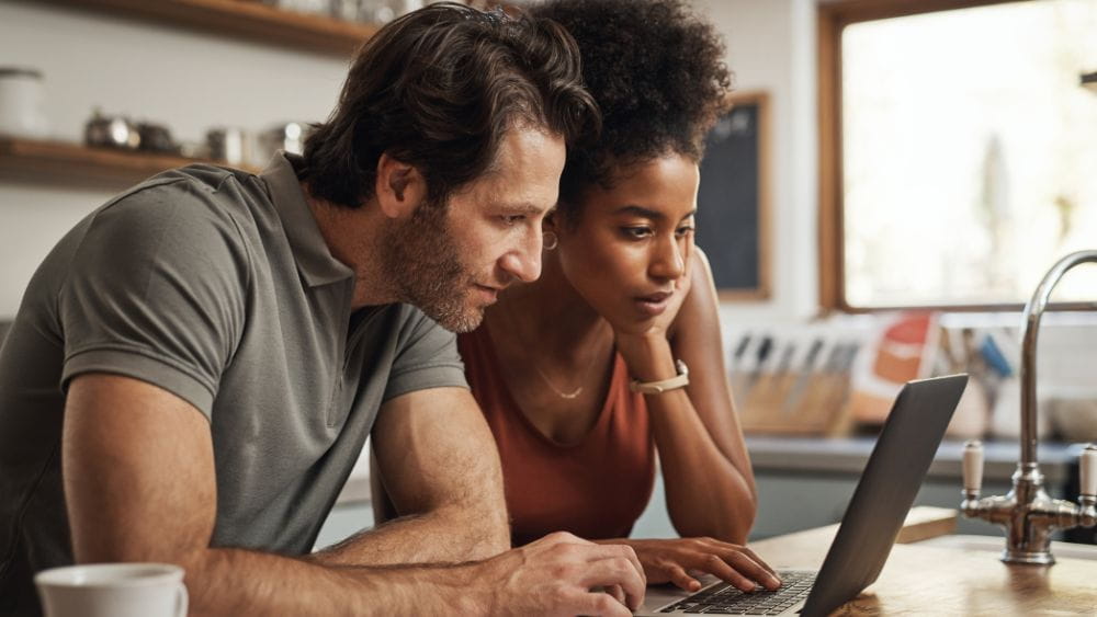 Couple looking at laptop.