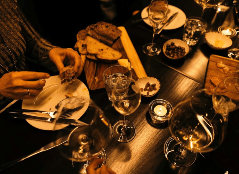 A table of people enjoying a meal at Cellar 495.