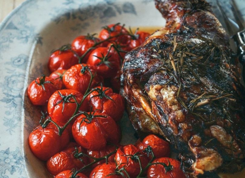 Slow roasted leg of lamb with vine ripened tomatoes.