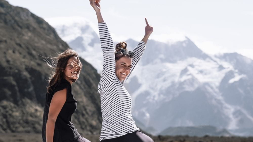 girls sitting on the edge of the hills